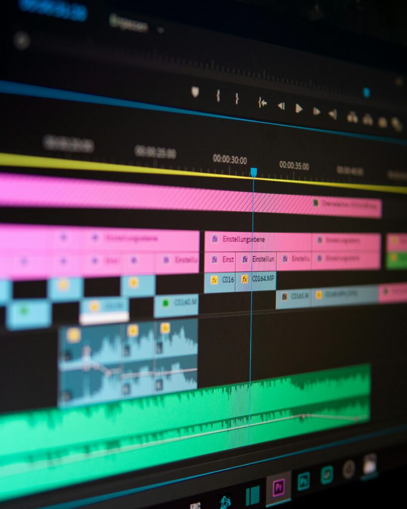screen with video editing software and many clips of video and audio being worked on